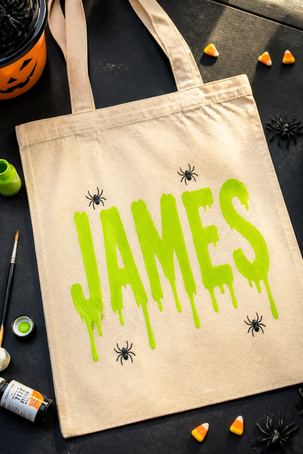 Name in Dripping Slime Letters — Write the child's name in tall block letters with a lime-green fabric marker, then add drip lines hanging from the bottom edge