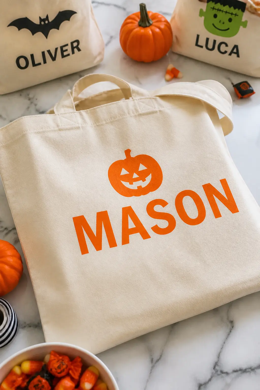 Name in Orange HTV With Jack-O-Lantern Icon — Cut a child's name in a bold sans-serif font from orange heat transfer vinyl, then cut a small jack-o-lantern