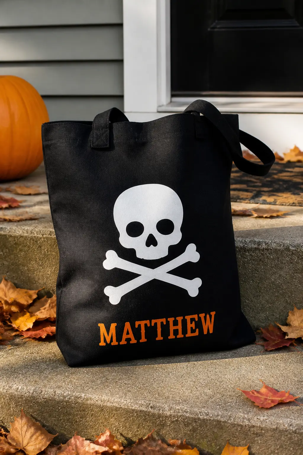 Skull and Crossbones in Classic White — Cut a clean graphic skull with crossed bones underneath from white HTV and press it centred on a black canvas bag.
