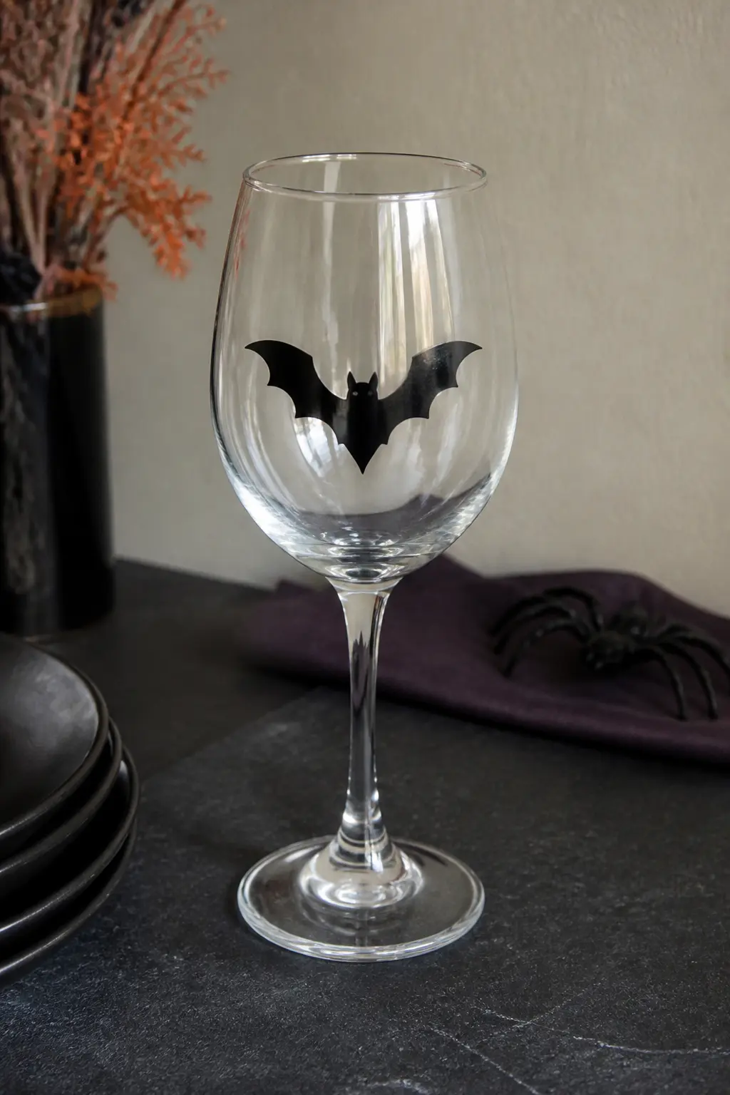 Single Bat Silhouette — One bat, dead centre on the bowl of a stemmed wine glass, painted in flat black. Halloween wine glasses diy