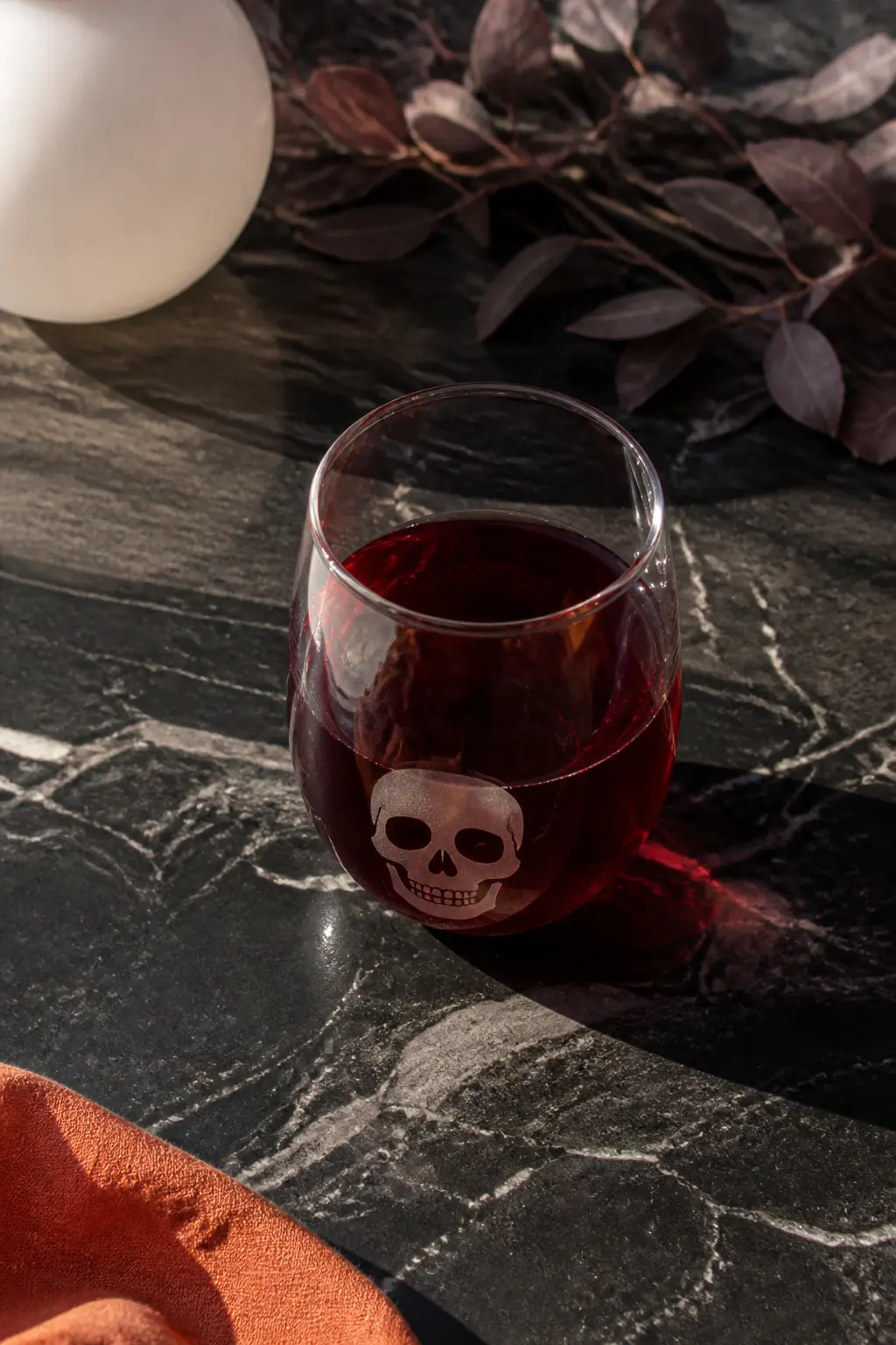 Skull Etched Stemless — A vinyl skull stencil, fifteen minutes of etching cream, and a rinse under cold water produce a frosted skull that sits just above the