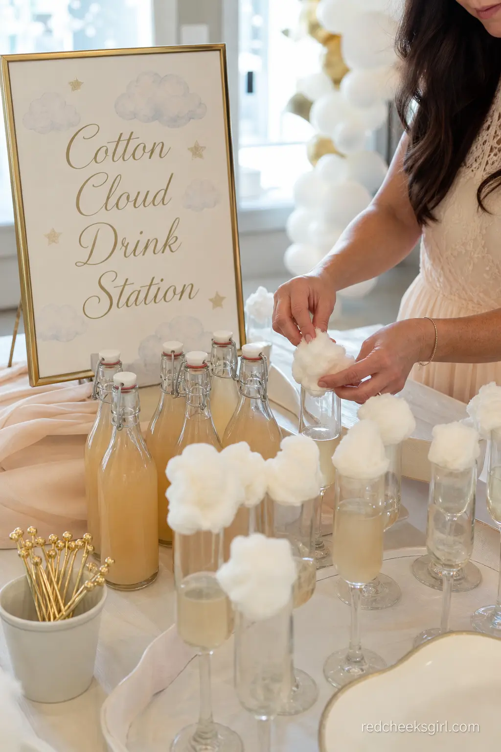 A Cotton Cloud Drink Station — Fluffy cotton candy, torn into small tufts and rested on top of a mocktail or a fizzy "mom-osa," turns an ordinary drinks table