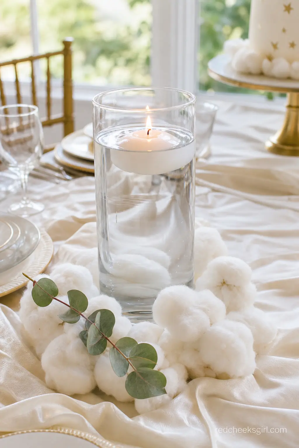 A Floating Candle Centerpiece With Cloud Tufts — Tall clear cylinder vases, filled with water and a single floating votive, sit low enough that guests can see
