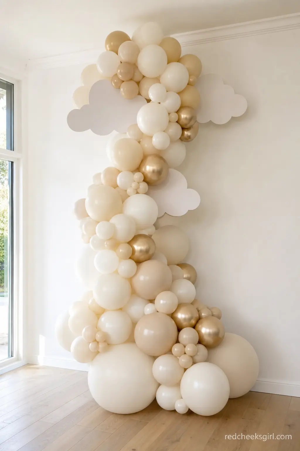 An Ivory and Champagne Cloud Arch — Organic balloon garlands have earned their reputation for a reason: loosely clustered, in two or three close tones, they
