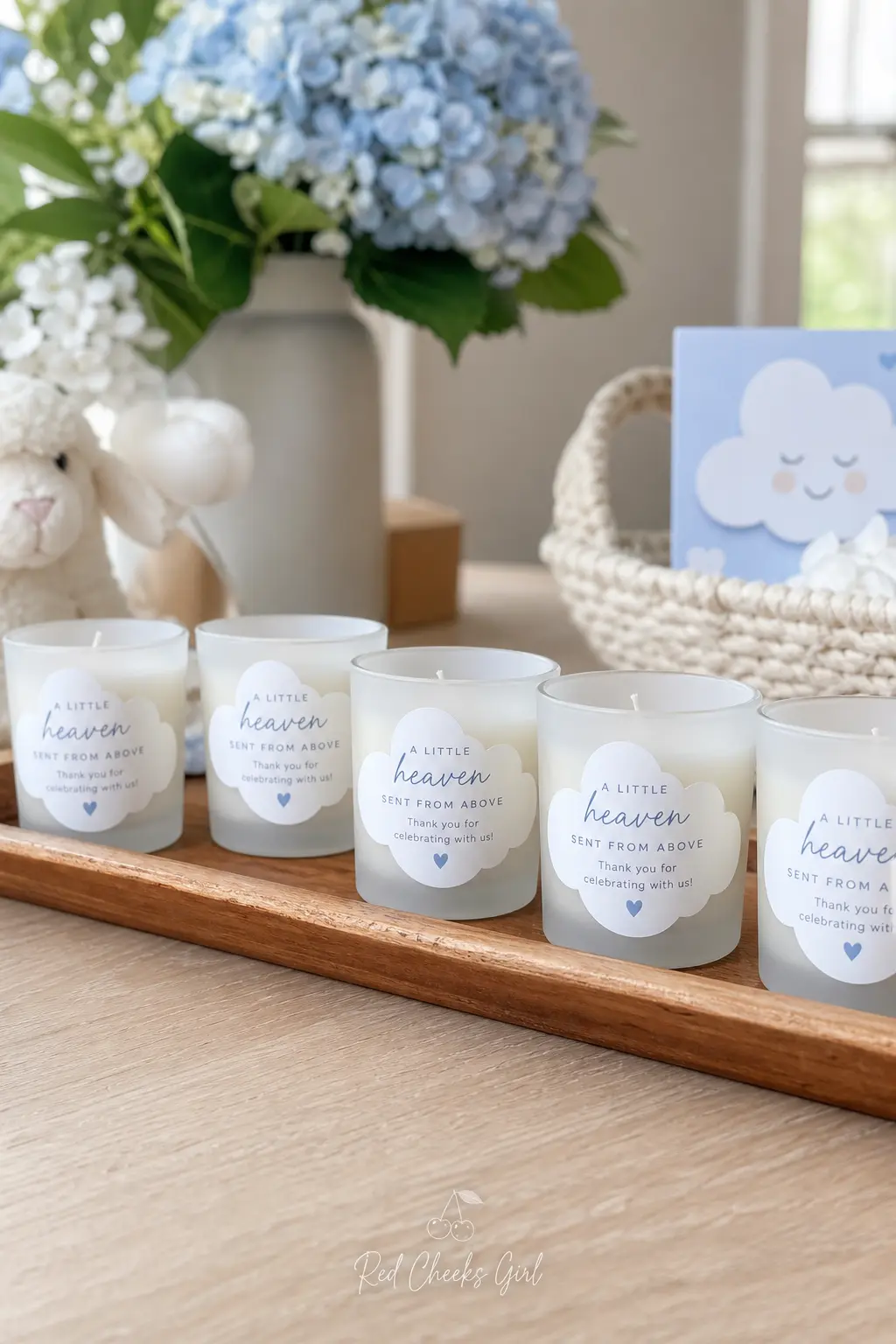 Personalized Cloud Candle Favors — A row of small ivory candles, each set in a frosted glass jar with a cloud shaped label, gives guests something they will