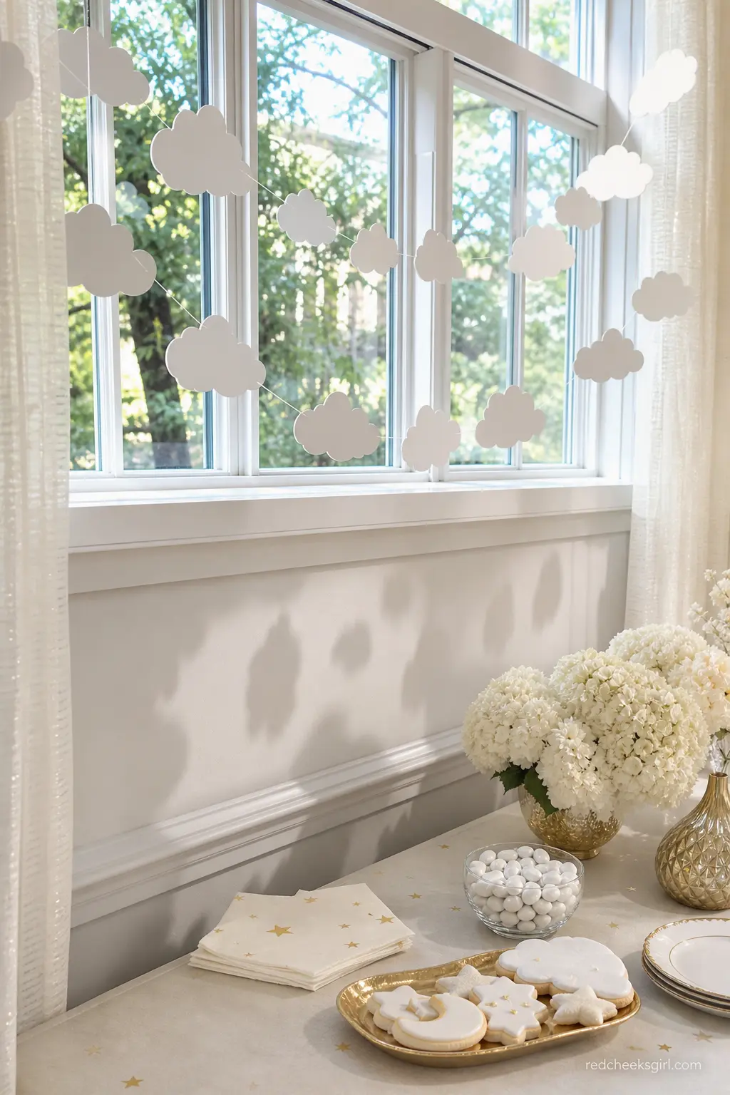 A Suspended Paper Cloud Garland — Card stock clouds, machine sewn into a long strand and hung across a doorway or window, give height and softness without the