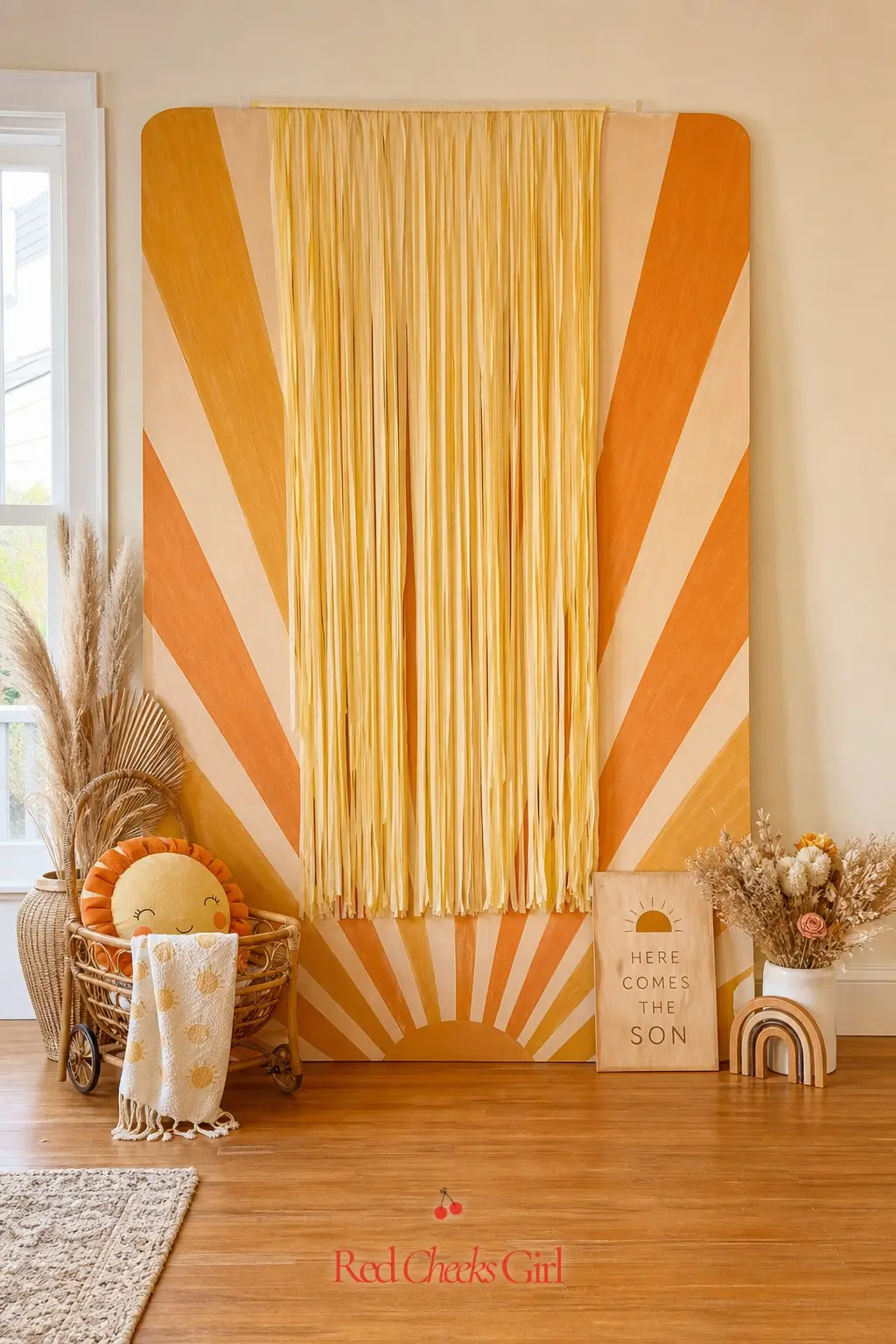 Hand-Painted Sunburst Mural Backdrop — A painted panel of radiating rays in orange and gold gives you a proper photo backdrop without renting a step and