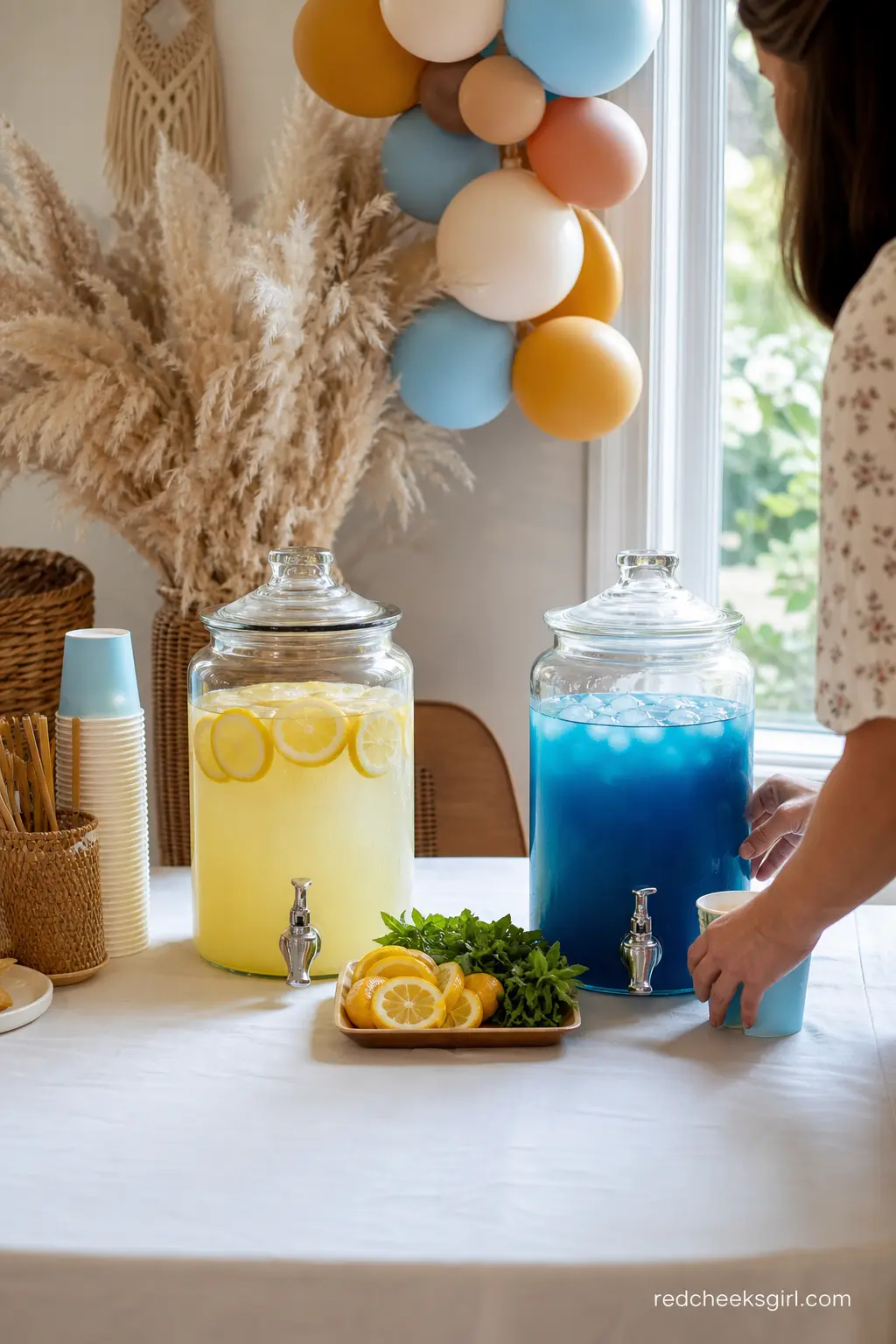 Lemonade and Blue Iced Tea Drink Station — Two glass beverage dispensers side by side, one filled with pale yellow lemonade and one with butterfly pea flower