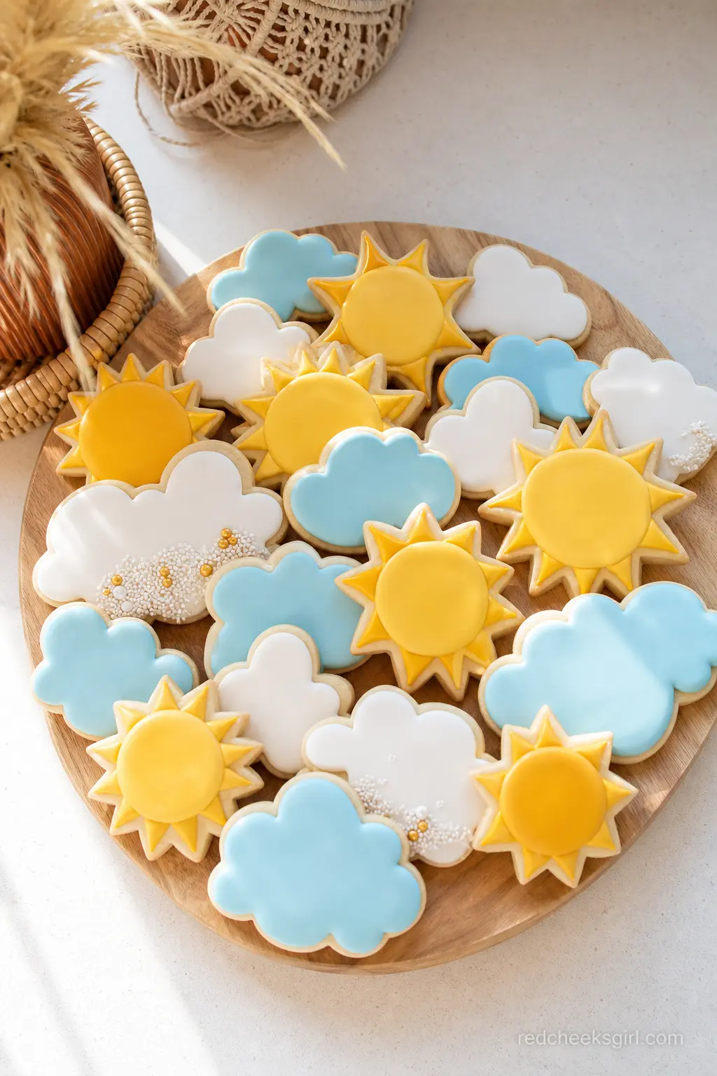 Sun and Cloud Sugar Cookie Platter — Iced sugar cookies shaped like suns and clouds in yellow, white and sky blue fill a wood board as an easy