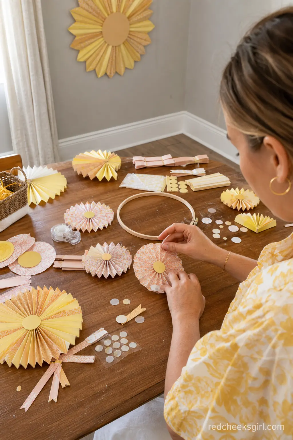Paper Sun Mobile Craft Corner — A small craft table with paper fan kits and glue dots lets guests build a paper sun mobile to take home or hang in the nursery