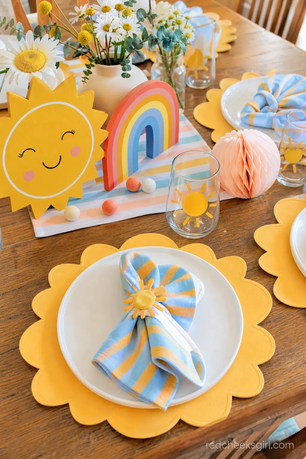 Retro Rainbow Tablescape — Striped napkins in sky blue and marigold, paired with plain white plates and a scalloped sun-shaped paper charger, nod to the retro