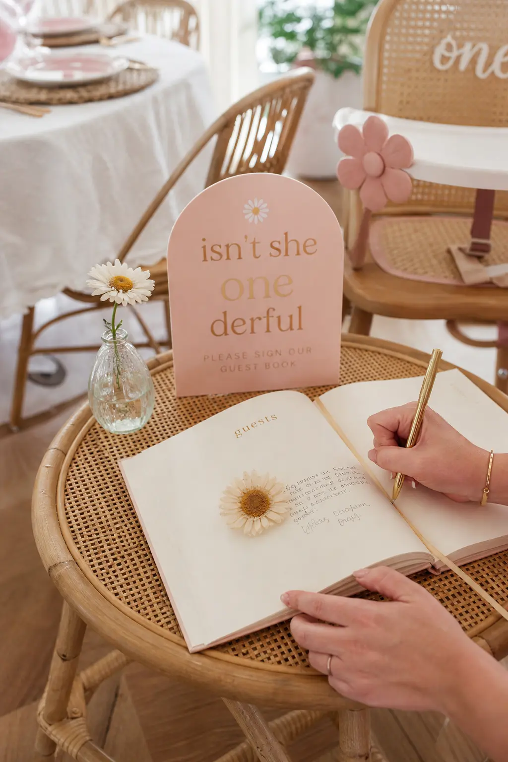 Floral Bound Guest Book Corner — A small table with an open book and a pen catches well wishes without asking anyone to stand in line, and a dried daisy used