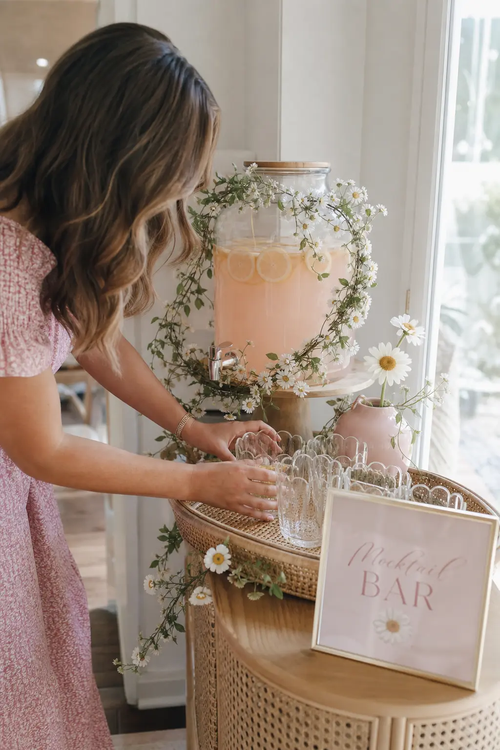 Scalloped Glassware Mocktail Bar — A single dispenser of pale pink lemonade wrapped in a fresh daisy garland does more for the drinks table than a full bar