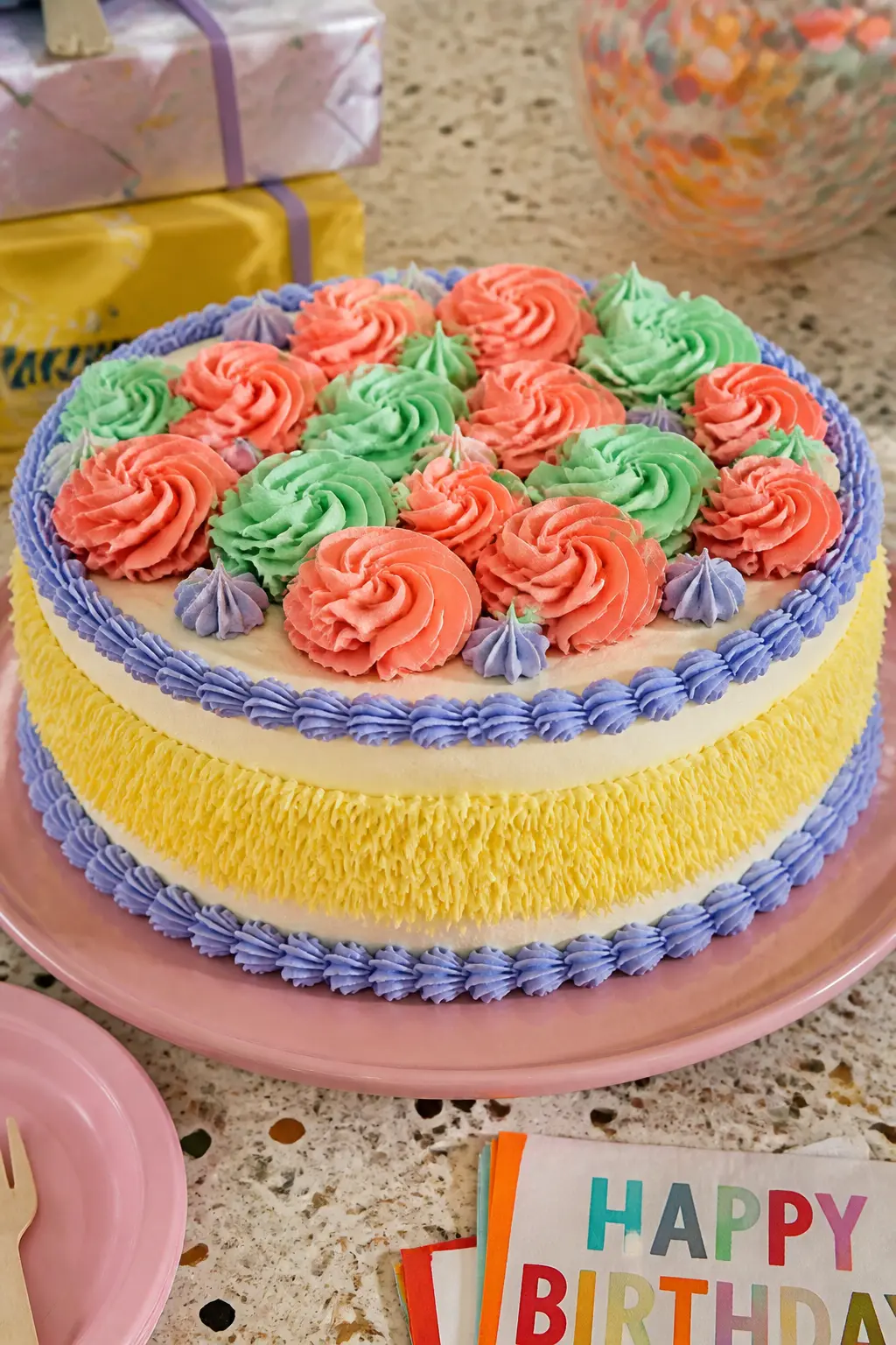 Sherbet Lemon and Periwinkle Fringe Cake — Grass-tip fringe, usually associated with shaggy textured cakes, becomes a Lambeth element when it is paired with