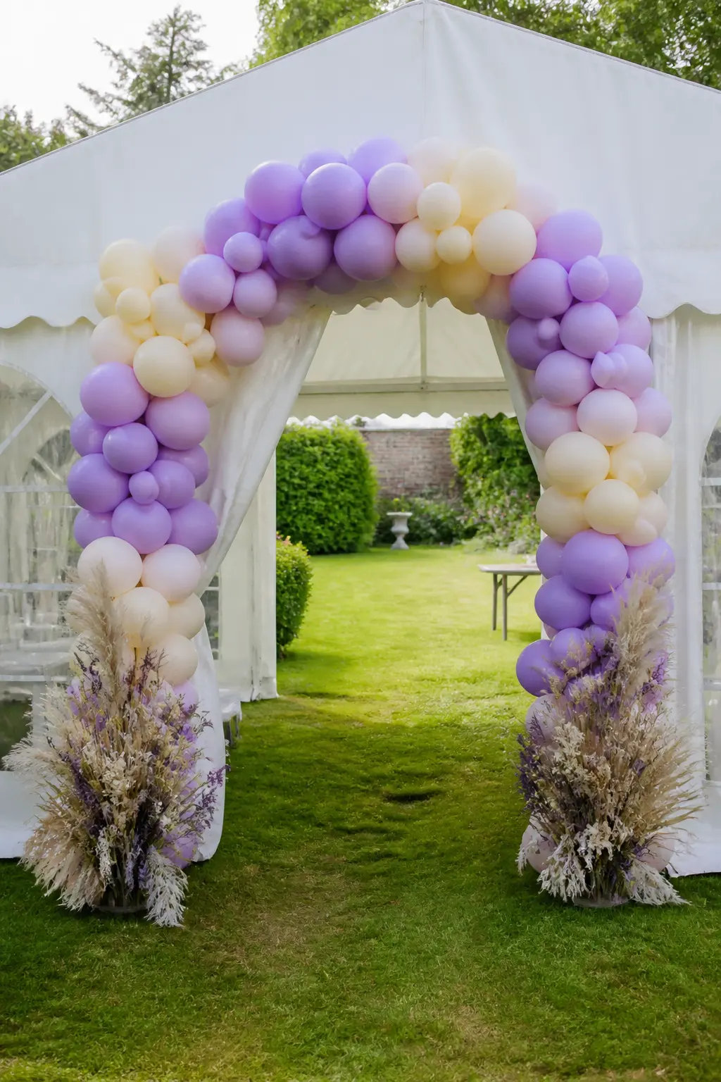 Lavender and Cream Arch at a Marquee Entrance with Dried Flowers — A marquee entrance arch needs to be proportionate to the structure: a small cluster looks