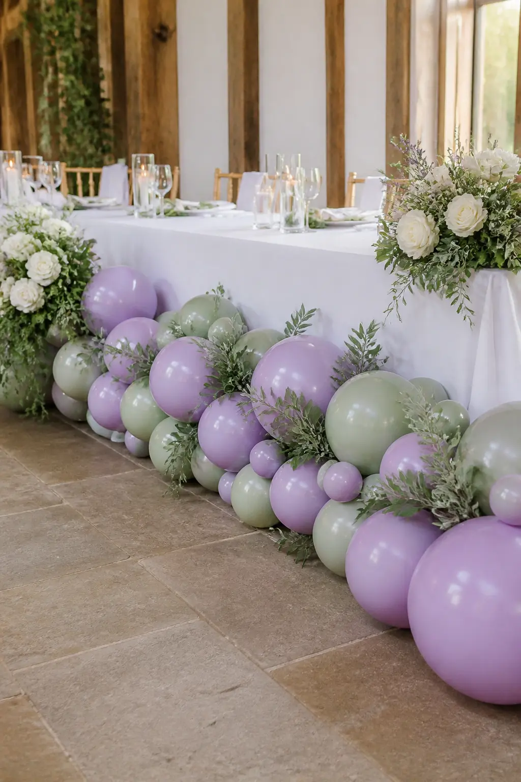 Lavender and Sage Garland Along a Spring Wedding Top Table — A garland rather than an arch suits a top table because it runs the length of the setting without