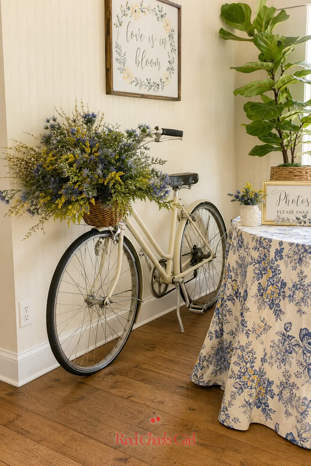 Vintage Bicycle Photo Corner — A cream bicycle with a basket spilling dusty blue and yellow wildflowers gives the room a soft, storybook corner without any