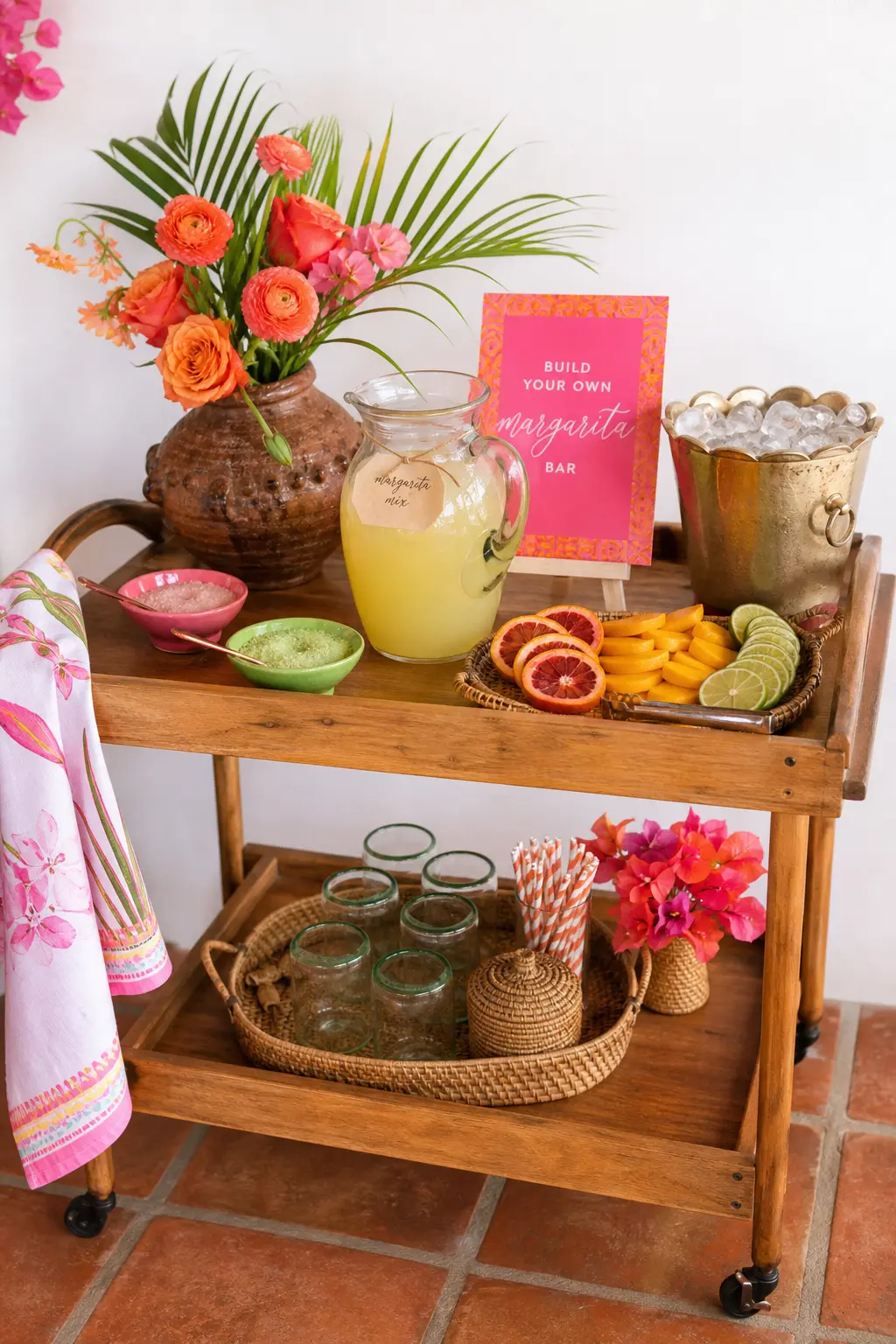 Build-Your-Own Margarita Bar — Set up a low sideboard or bar cart with everything a guest needs to build her own margarita: a large jug of pre-batched base