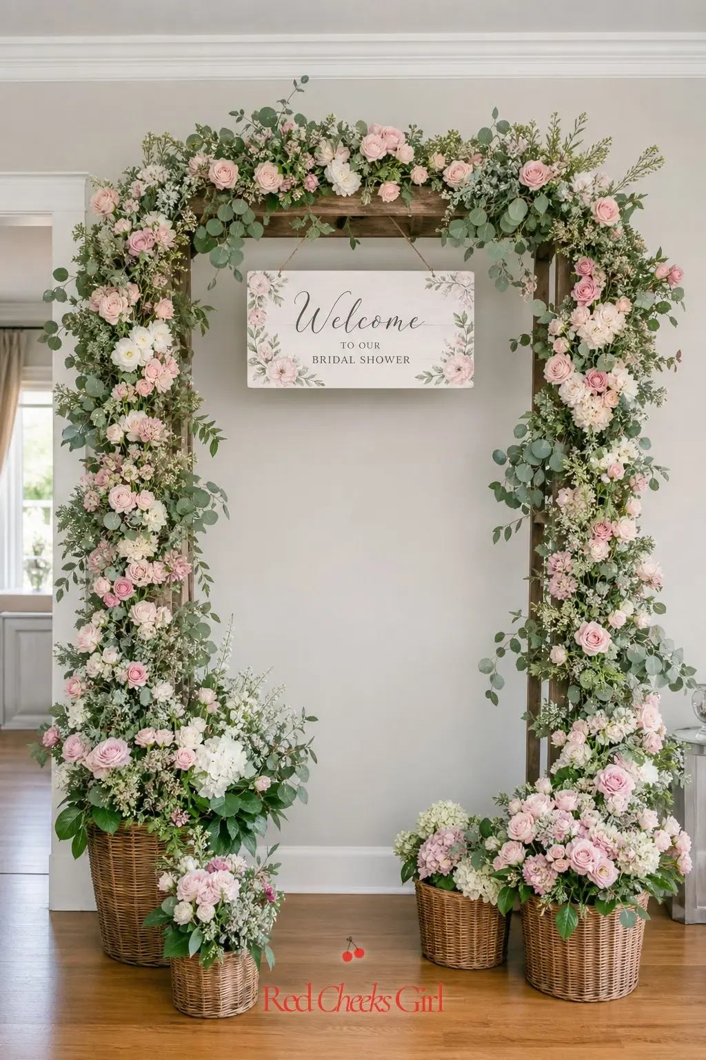 Flower Market Entrance Arch — A wooden arch dressed in blush and sage blooms frames the front door and gives every guest a reason to stop and take a photo