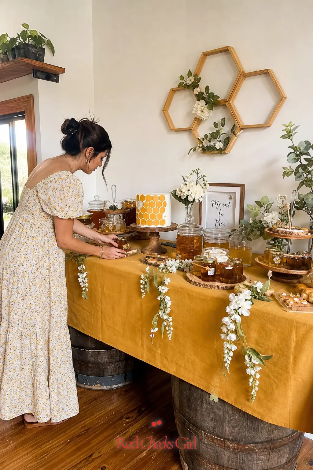 Honey Stand Dessert Table — A dessert table dressed in mustard linen, with small amber honey jars lined up beside a cake finished to look like honeycomb, gives