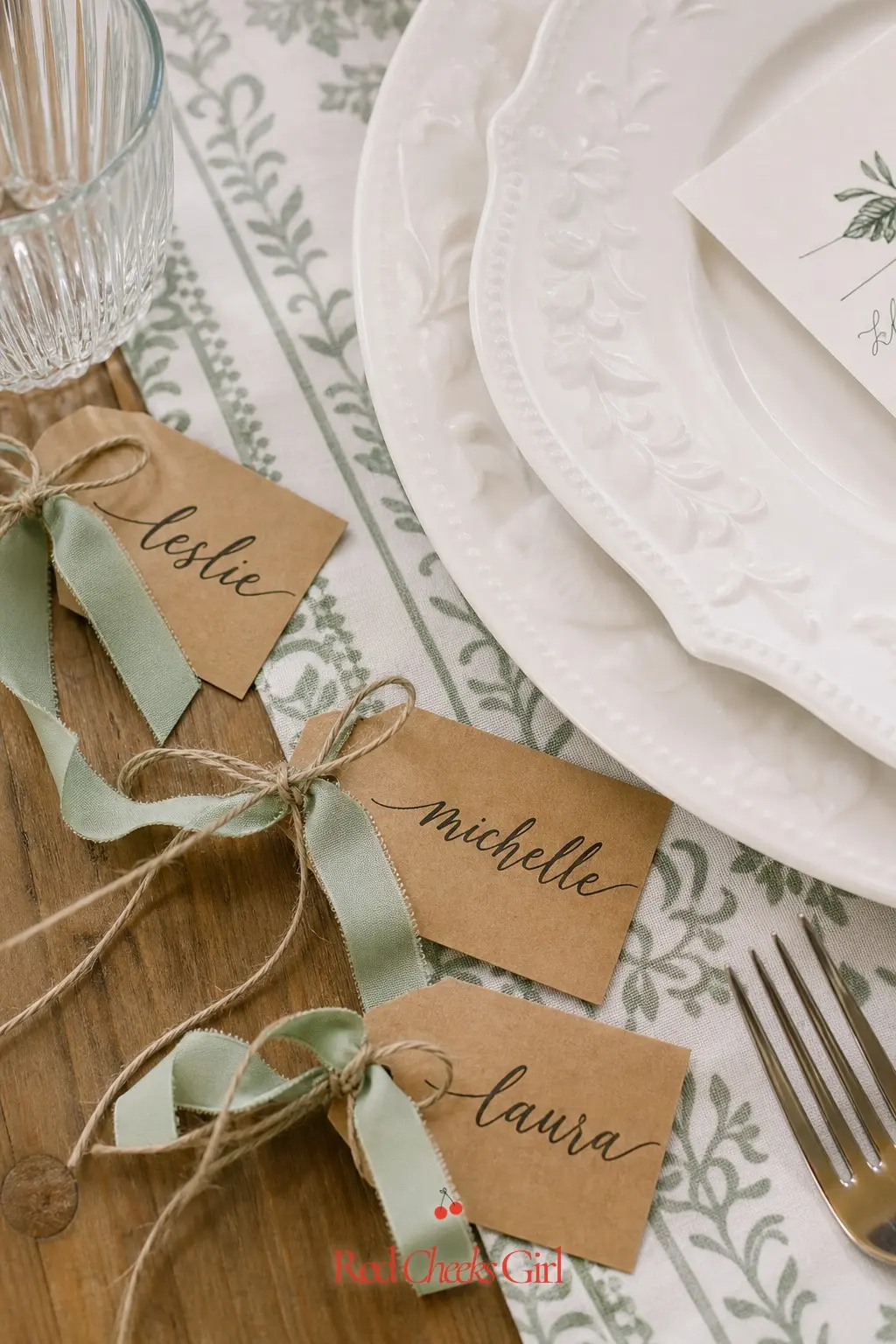 Ribbon Tag Place Cards — Small kraft tags tied with natural twine and a scrap of sage ribbon, laid beside each plate with a guest's name, cost pennies but keep