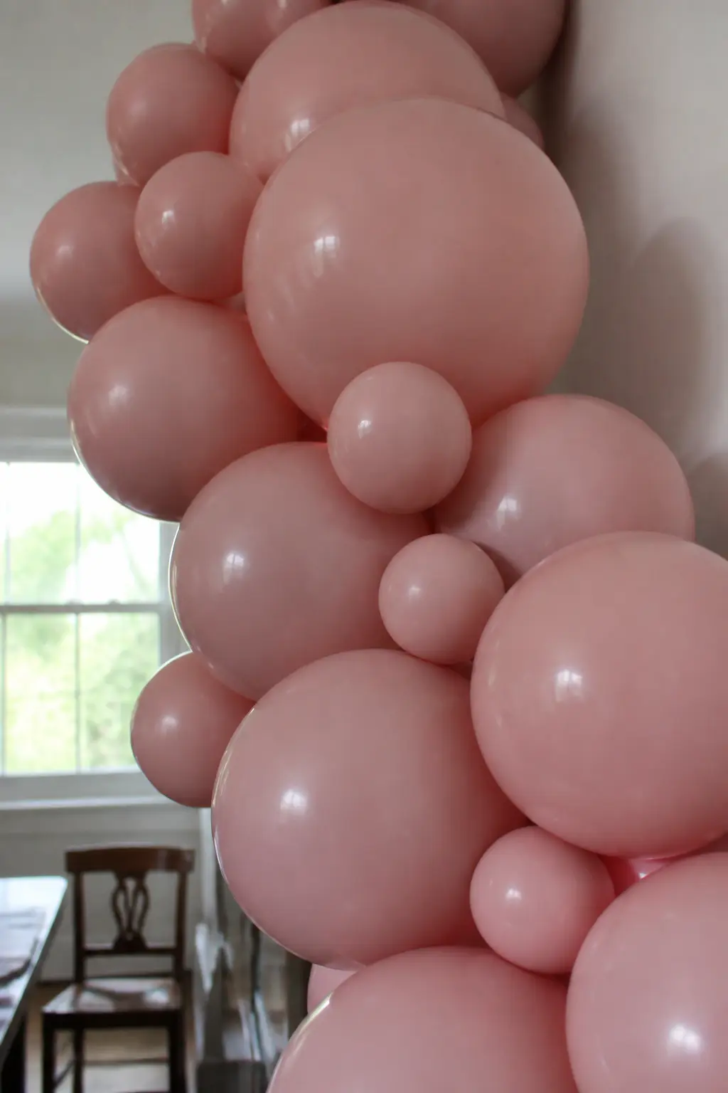 Method: Mix Balloon Sizes Within Each Shade — A garland built from balloons of a single size looks machine-made. Ombre balloon arch