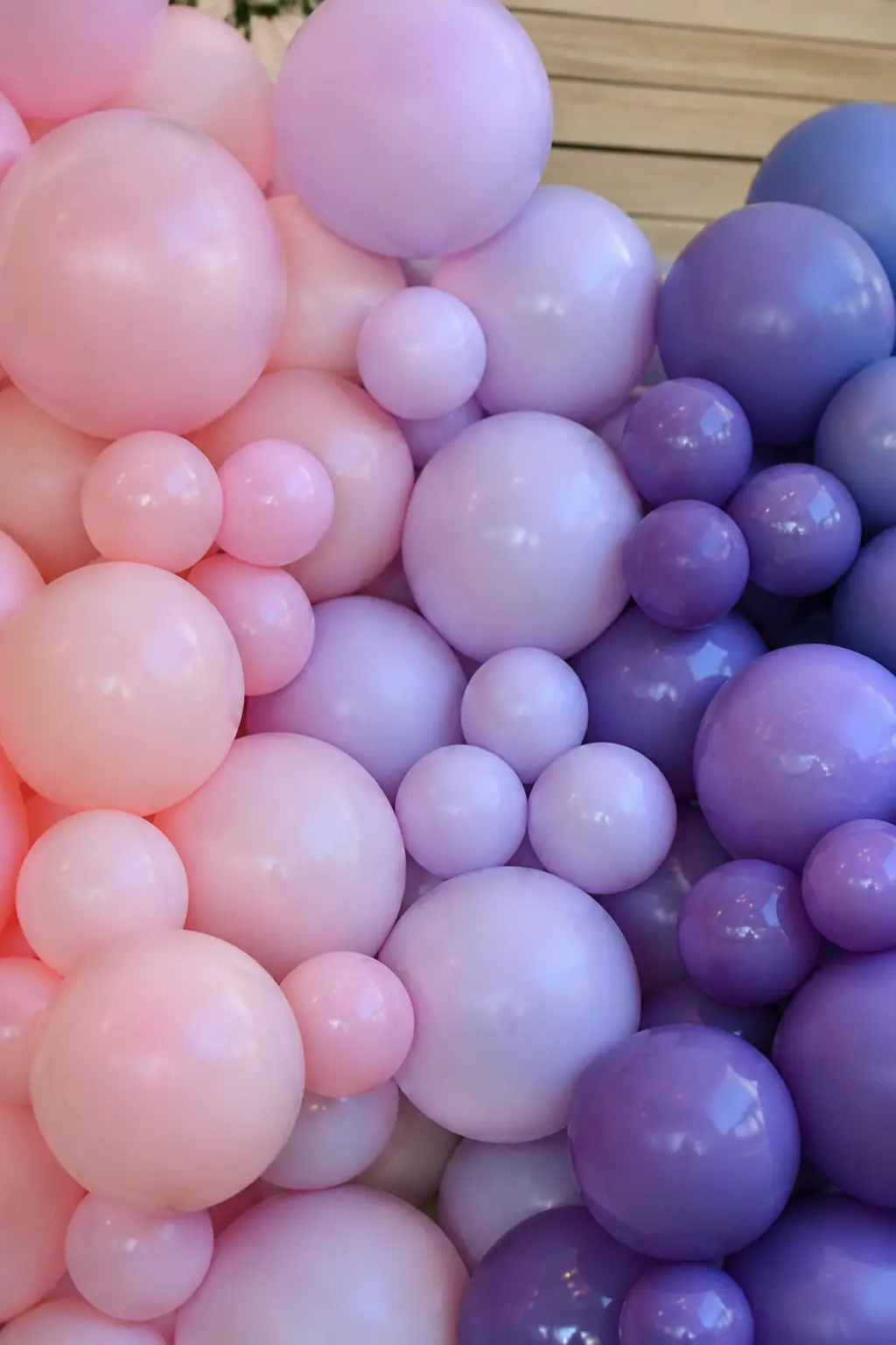 Method: Overlap Two Shades in Each Transition Zone — A transition zone is the stretch of garland where shade A hands off to shade B. Ombre balloon arch