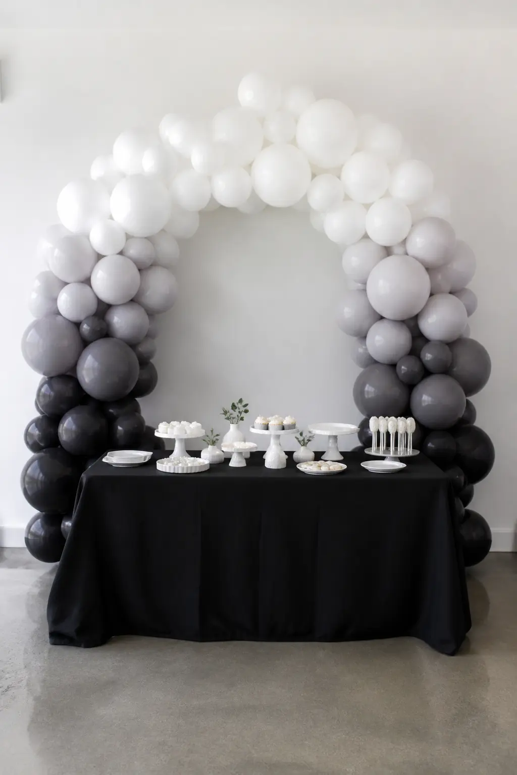 White to Charcoal Behind a Modern Flat's Dessert Table — This arch is for the host whose flat has concrete floors and white walls and does not want anything