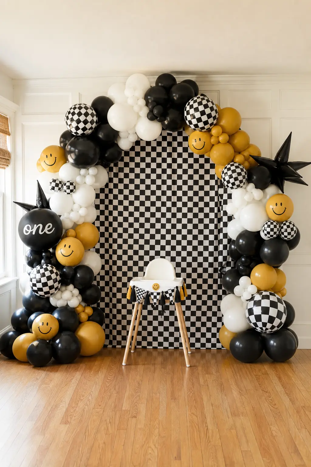The Full-Wall Checkerboard Balloon Arch — This is the splurge version: a floor to ceiling organic balloon arch in black, white and mustard, with a folded