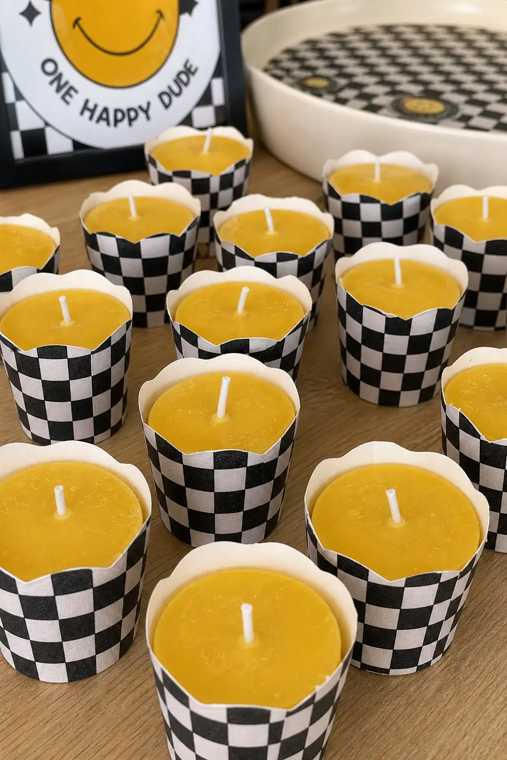 Mini Candle Favors in Checker Wrap — Small mustard yellow candles wrapped in black and white checker paper make a favor that adults keep on a shelf rather than