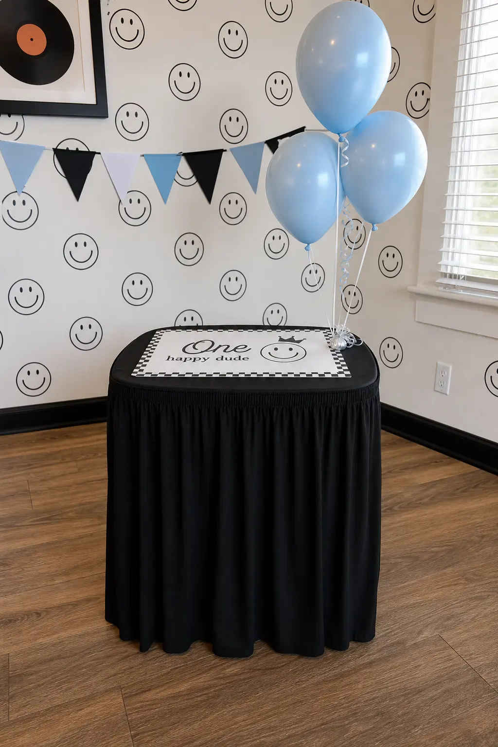 The Skirted Smash Table — If you would rather skip the high chair entirely, a small table wrapped in a black fabric skirt with a white smash mat on top gives