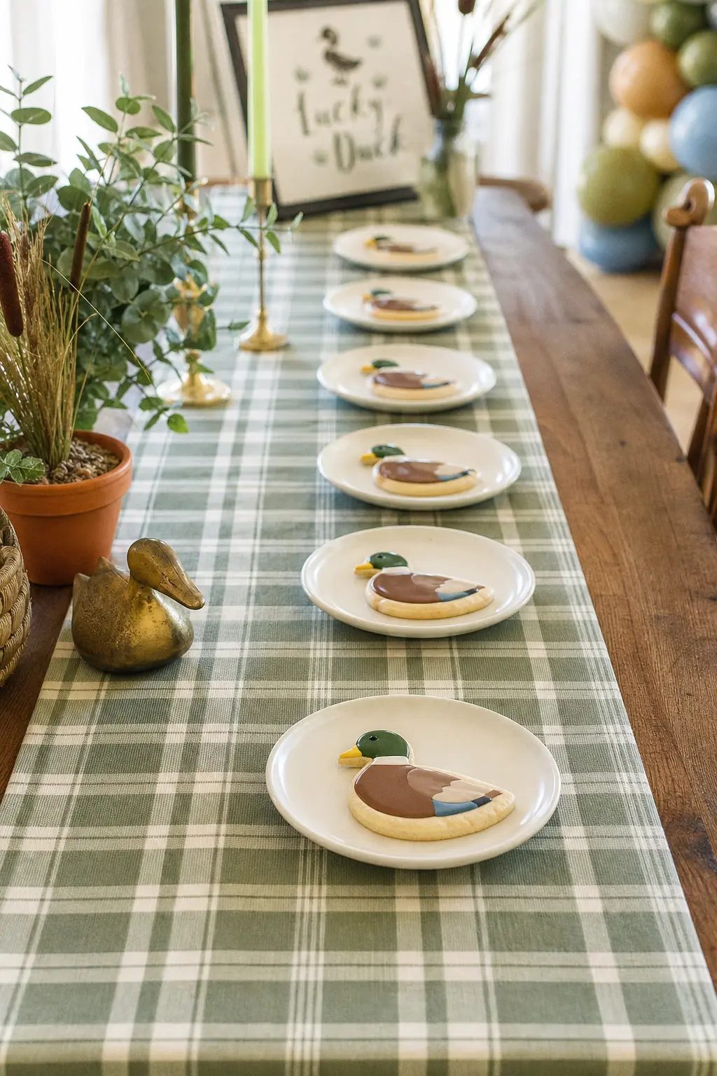 Plaid Runner Cookie Row — A plaid runner does double duty as the table's main texture, so the cookies on top of it can stay simple, just a mallard outline in