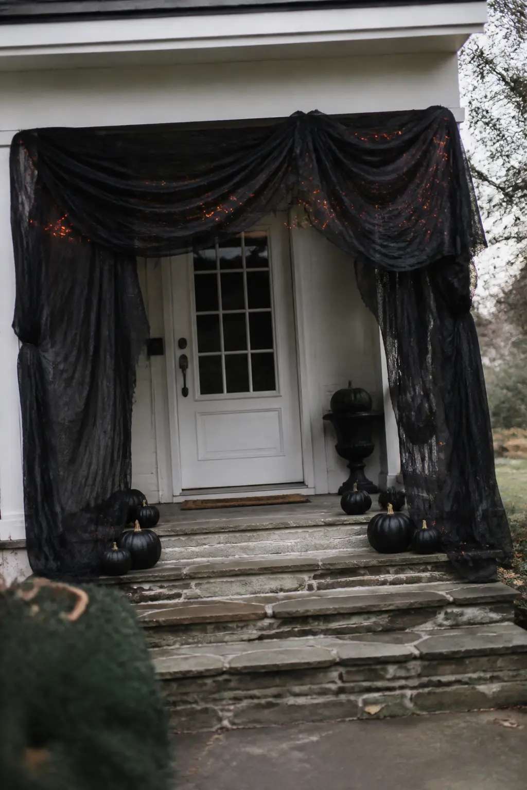 Black Draping Gathered Under a Porch Roof