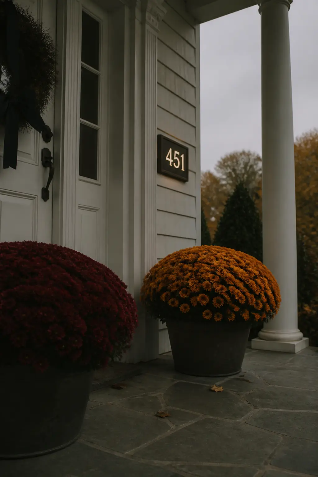 Illuminated Address Numbers Flanked by Mums