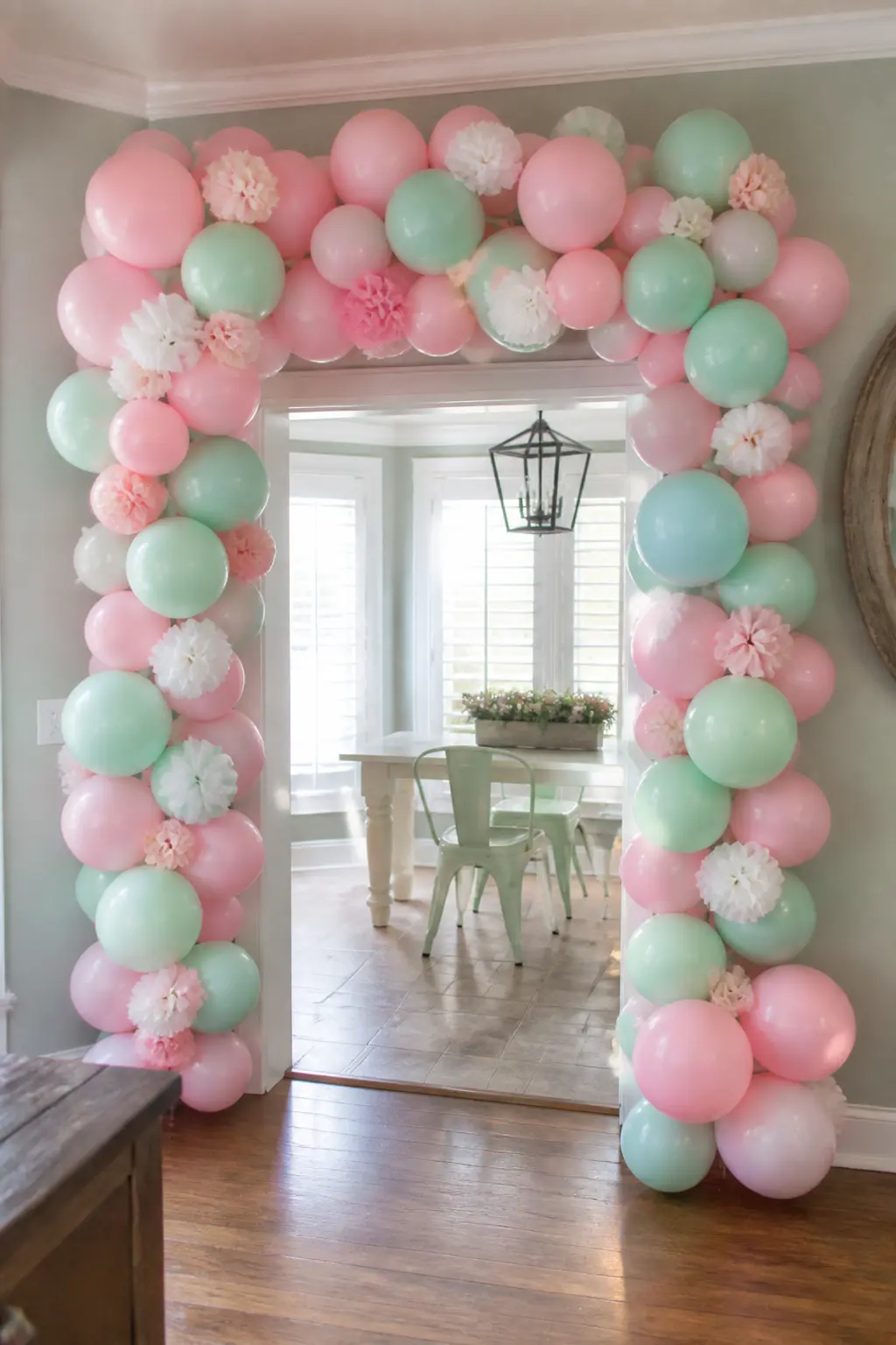 Blush and Mint Arch with Paper Flowers Pushed In for a Girls' Birthday — Paper flowers push into balloon clusters without deflating the balloons if the stem is