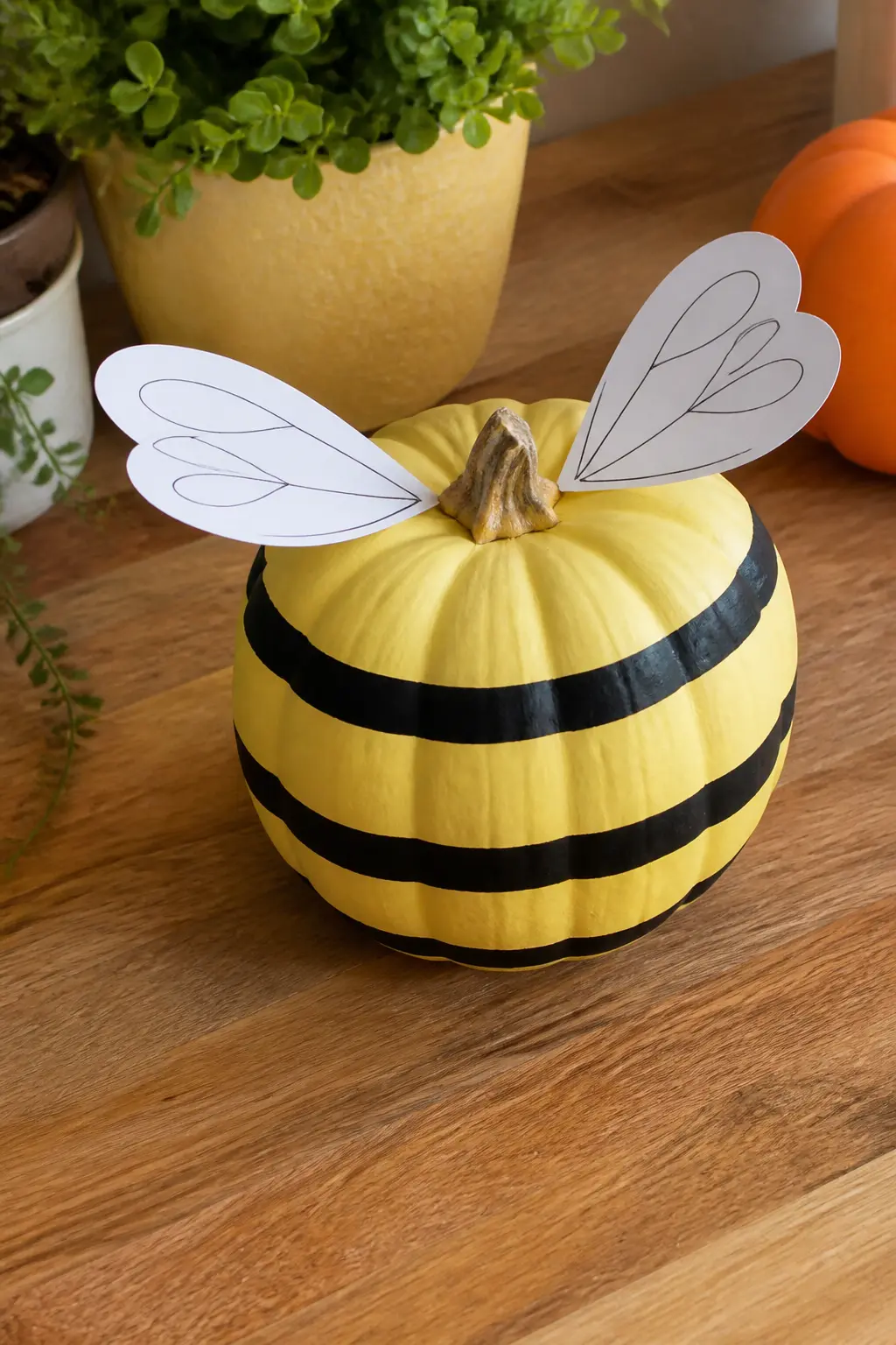 Butter Yellow Bee Pumpkin With Paper Wings — Paint the pumpkin in flat matte butter yellow. Pastel painted pumpkin