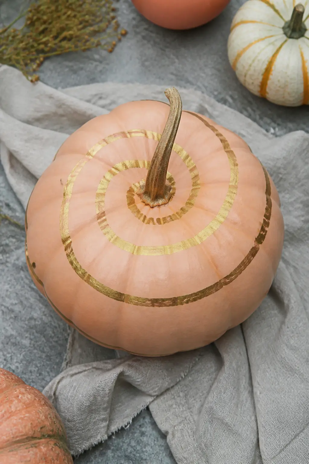 Peach Pumpkin With a Gold Spiral — Paint the pumpkin in flat matte peach. Pastel painted pumpkin