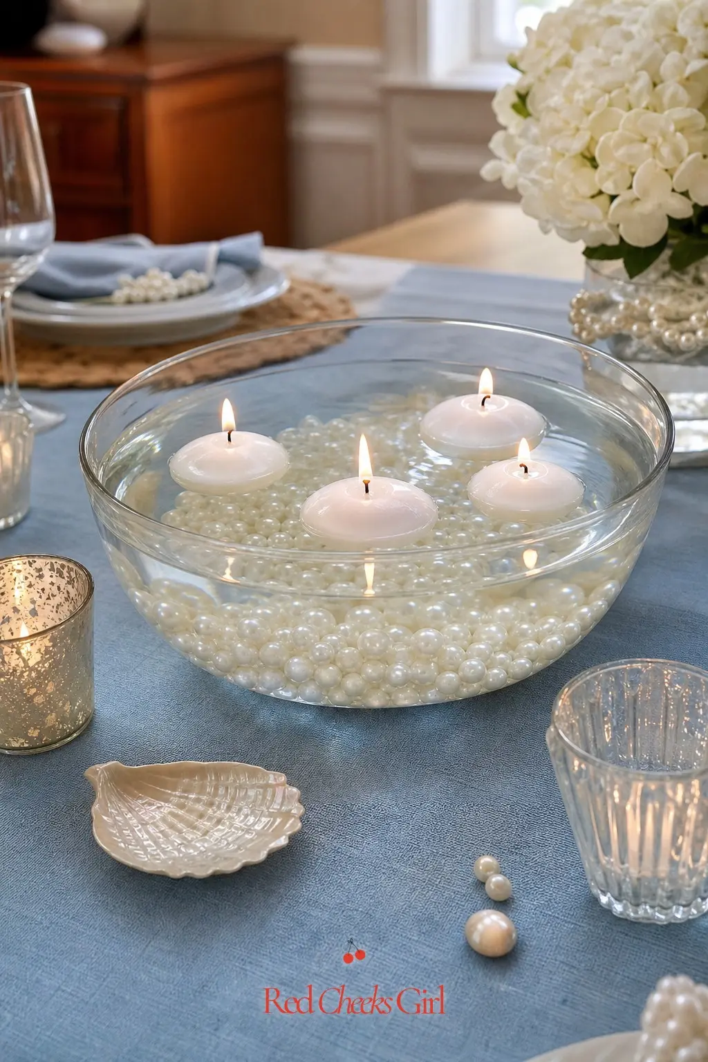 Floating Pearl Candle Centerpiece — Fill a wide glass bowl with water, drop in a handful of loose faux pearls so they sink and cluster along the bottom, then