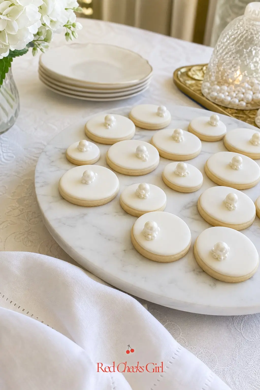 Pearl Sugar Cookie Platter — Round sugar cookies iced in white with a single piped pearl in the center are simple enough to make in one afternoon. Pearl theme
