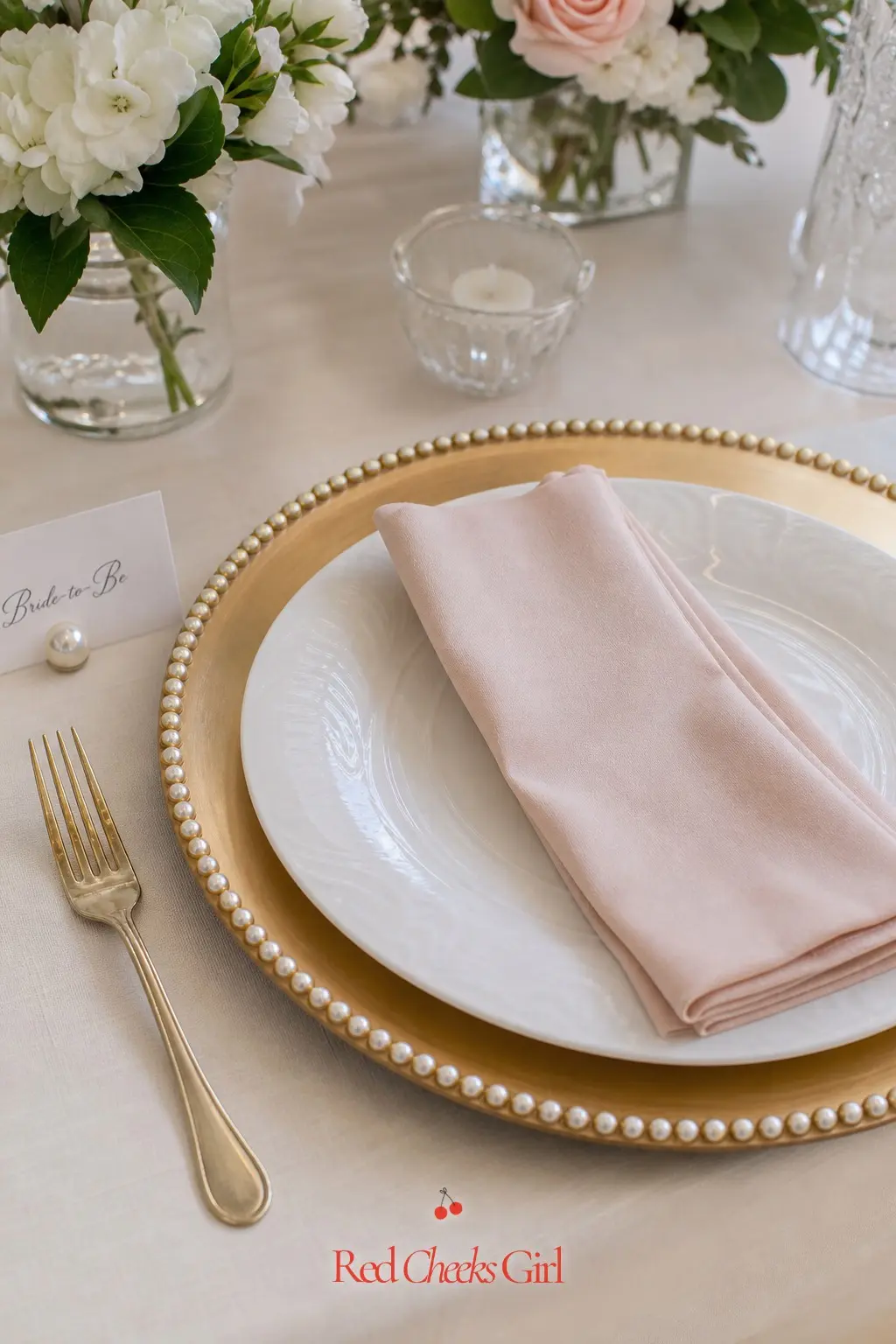 Pearl-Rimmed Charger Place Setting — A charger plate with a thin pearl border does more work than an expensive centerpiece, because every single guest gets one