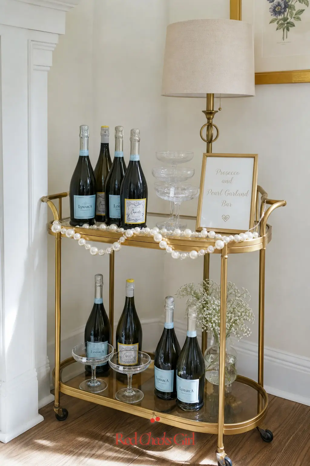 Prosecco and Pearl Garland Bar Cart — A small brass bar cart does more than a full drinks table, because it fits in a corner and still looks curated. Pearl