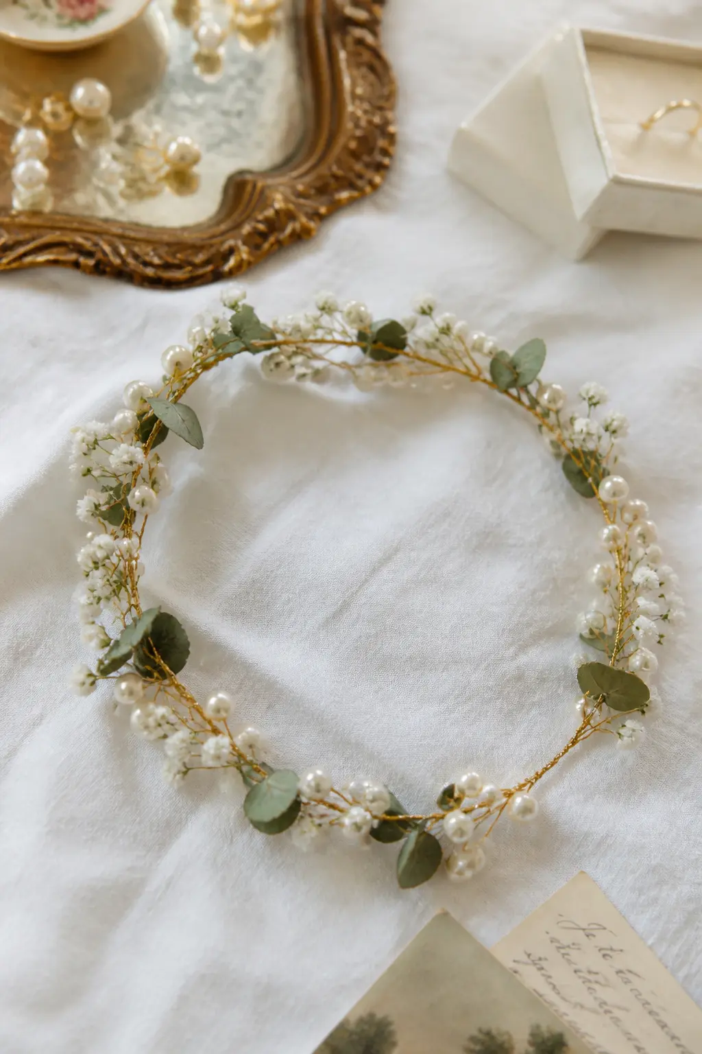Pearl-Threaded Floral Crown — A flower crown built on a thin wire base with small white blooms, greenery and individual pearl beads threaded onto fine wire and