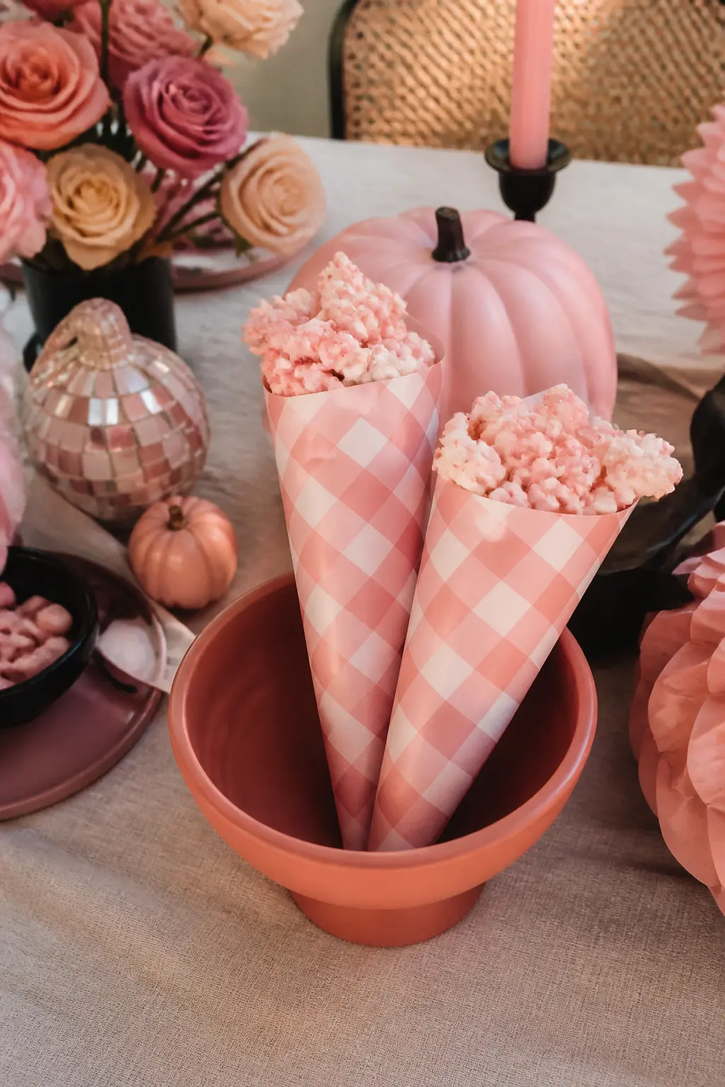 Blush Popcorn Bar with Checkered Cones — Tint popcorn with pink candy melts and pile it into tall checkered paper cones in blush and white. Pink halloween