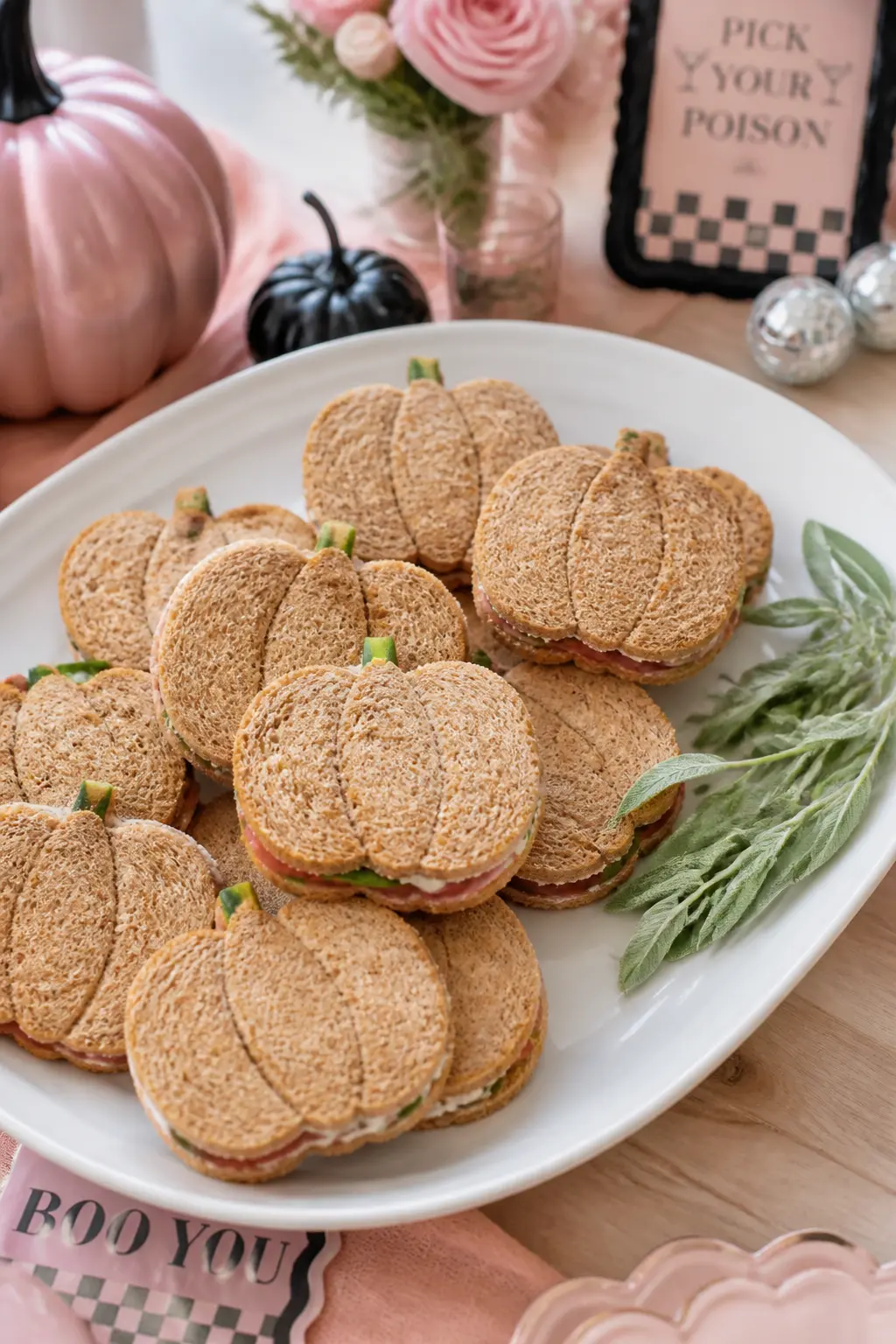 Pumpkin-Shaped Sandwich Stack — A pumpkin-shaped cookie cutter turns any filled sandwich into a finger food that fits the theme without requiring anything