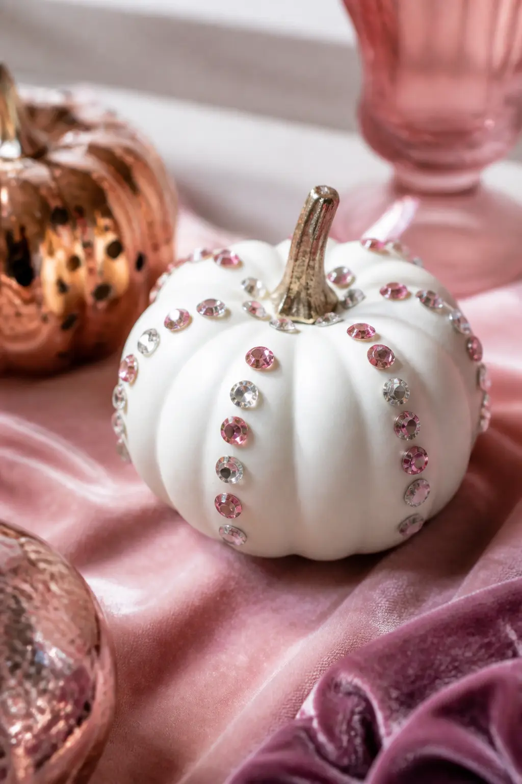 Rhinestone-Studded Mini Pumpkin — Hot-glue flatback rhinestones along the ridges of a white or blush-painted mini pumpkin, following the natural lines of the