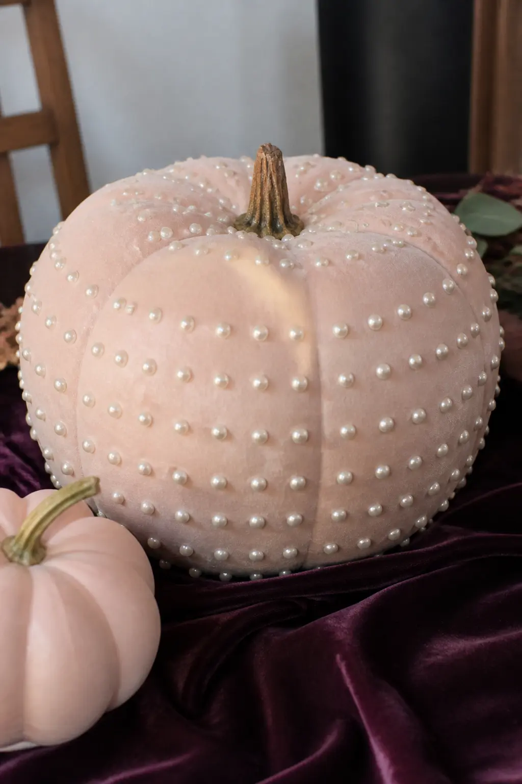 Blush With Pearl-Headed Pins — Push pearl-headed straight pins into the surface of a foam pumpkin in horizontal rows that follow the ridges. Pink painted