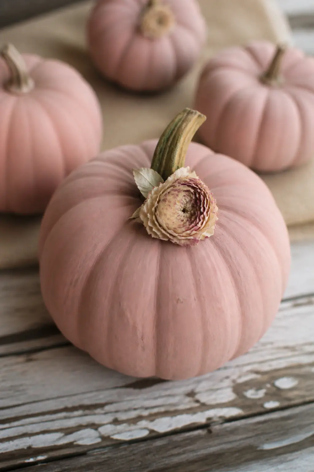 Dusty Rose With a Dried Flower at the Stem — Glue a single dried flower, or a small cluster of two or three, directly at the base of the stem where it meets