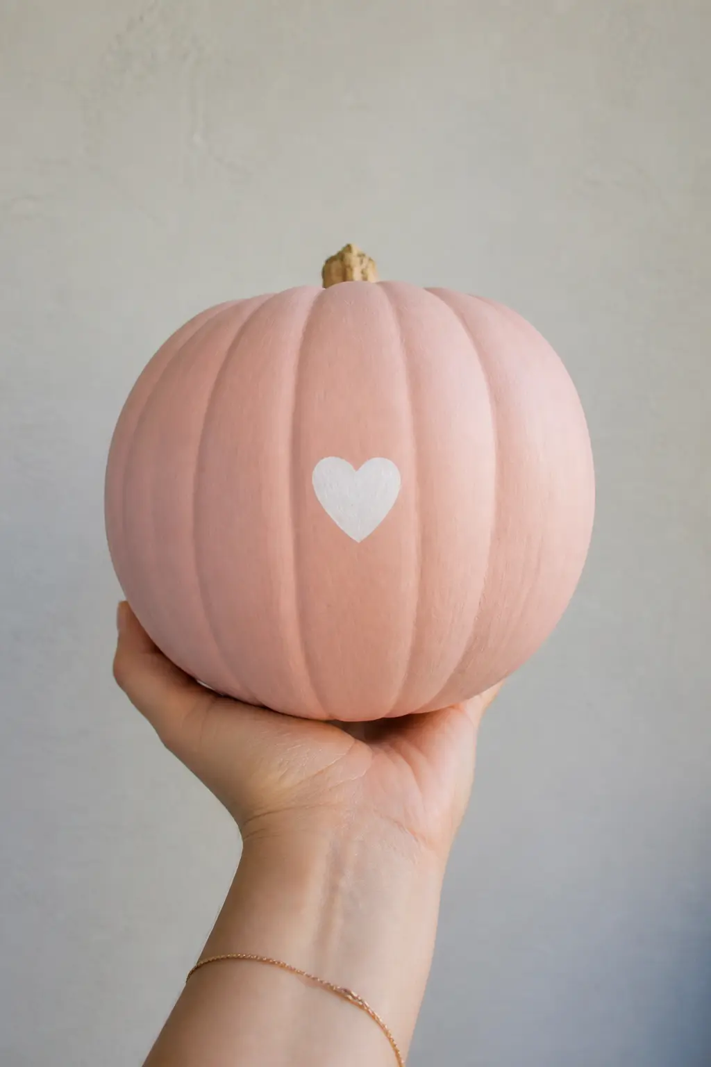 A Heart on the Back — Paint a small heart on the back panel of the pumpkin, where it faces the wall and nobody looks. Pink painted pumpkin