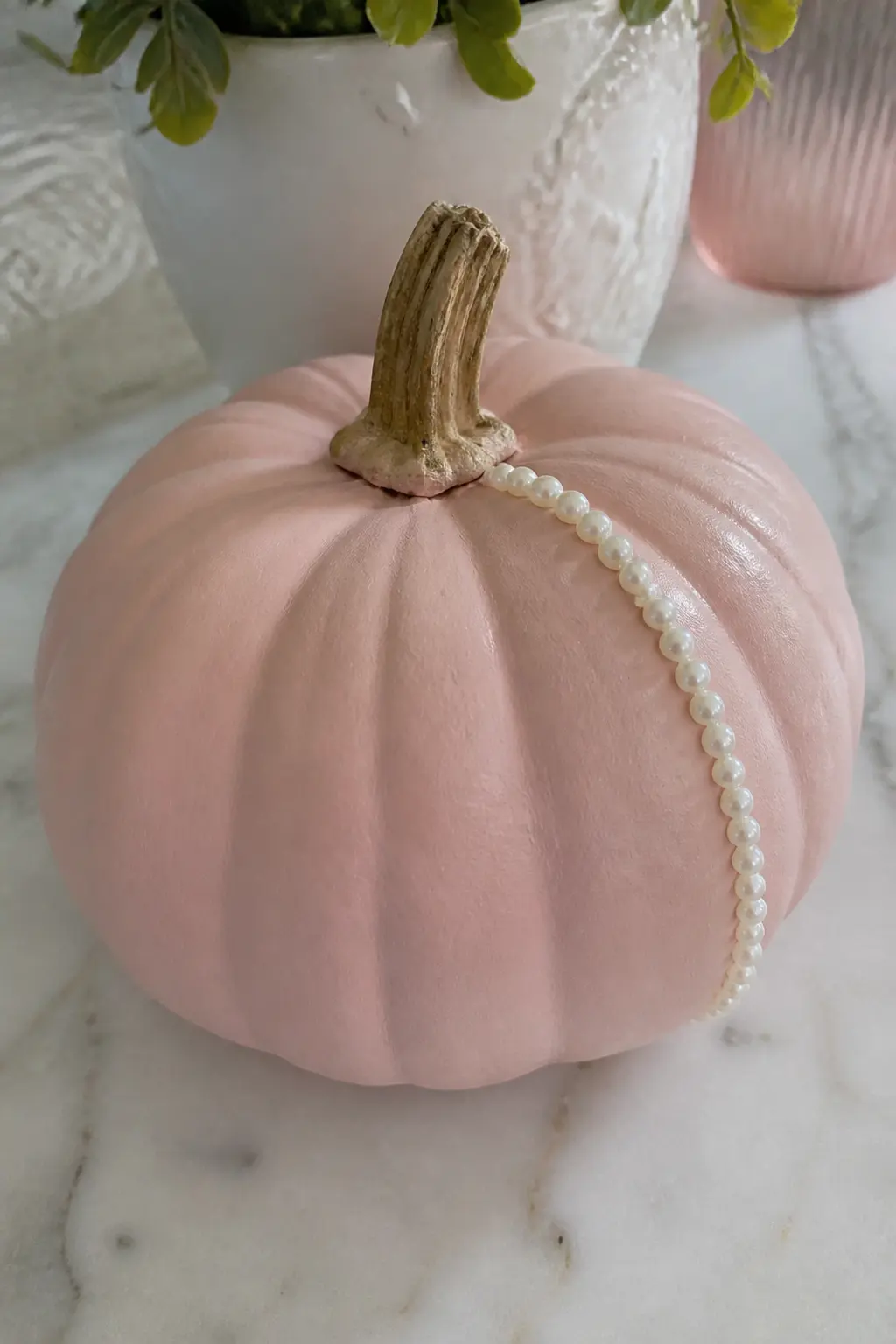 Pearls Glued in a Curving Line — Run a single curving line of pearl beads (flat-backed, so they sit flush) from the stem down one ridge and across to the front