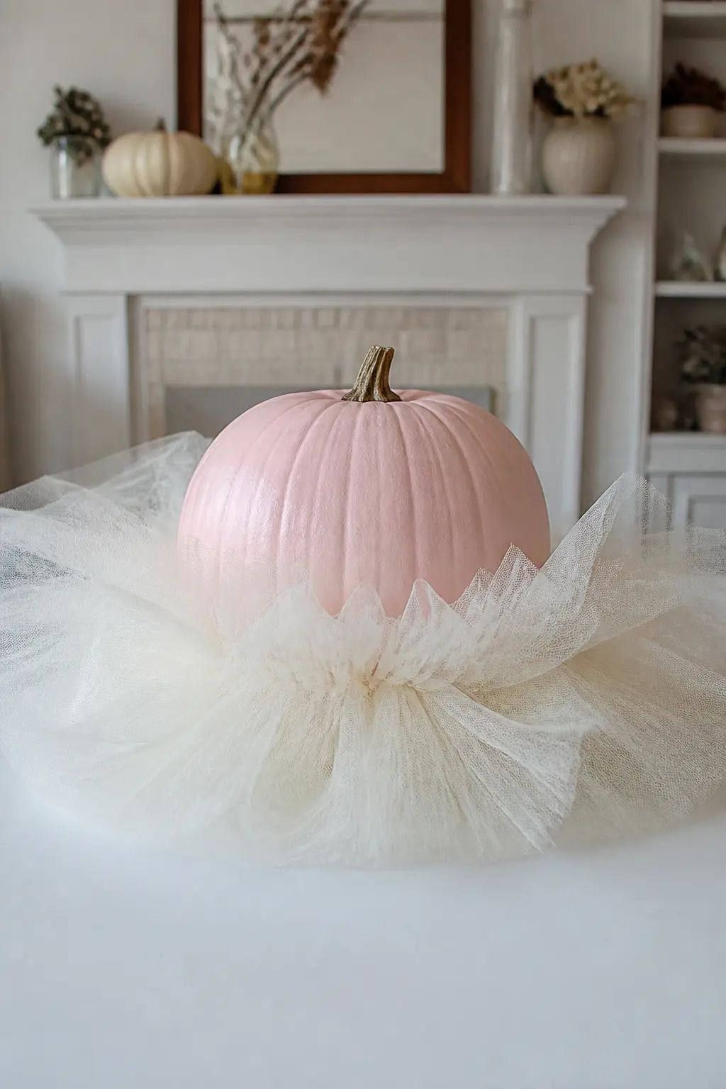 Tulle Gathered Around the Base — Cut a length of tulle wide enough to gather into a full ruffle and wrap it around the base of the pumpkin, hot-gluing the